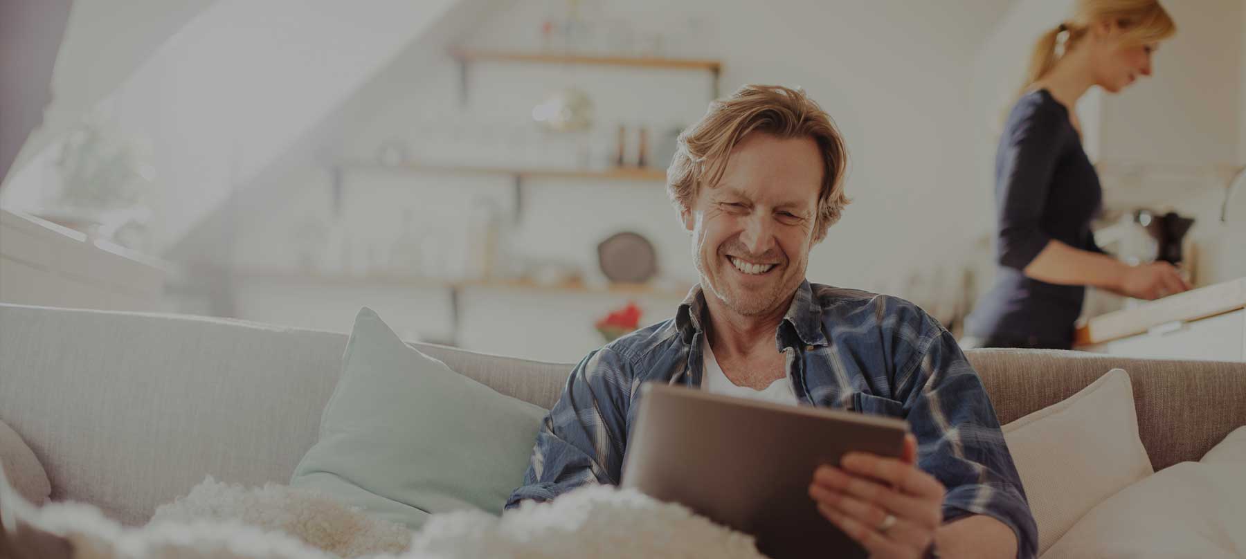 Smiling man using tablet